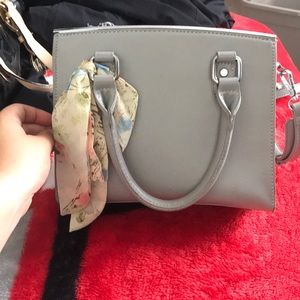 A grey cross body bag